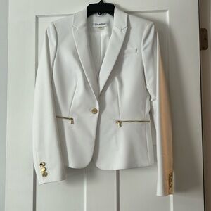 Pristine white blazer with gold buttons and zipper pockets